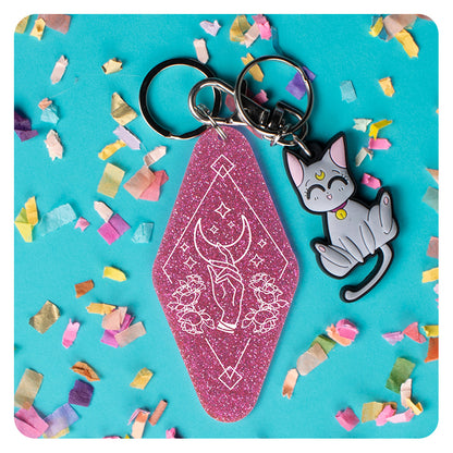 Hand Reaching for Moon Glitter Keychain