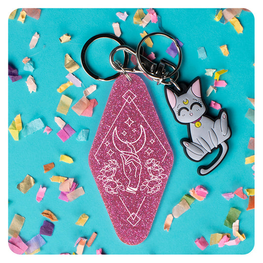 Hand Reaching for Moon Glitter Keychain